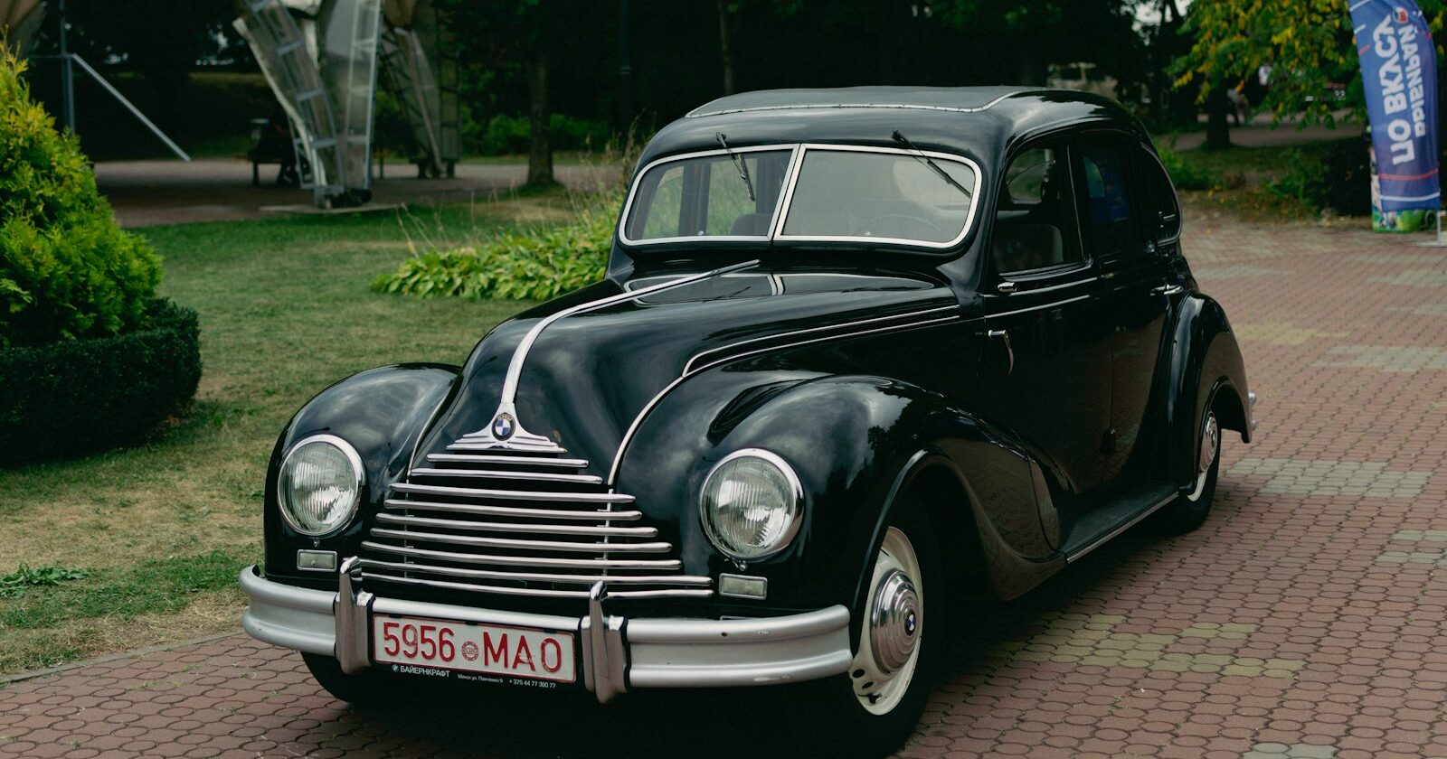 a black car parked on a brick road